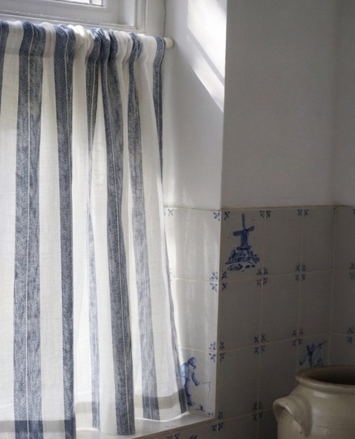 White and blue stripe cafe curtains in a kitchen