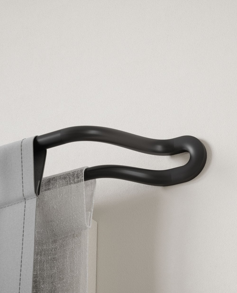 Black double curtain pole with a net curtain and a heavyweight curtain in front